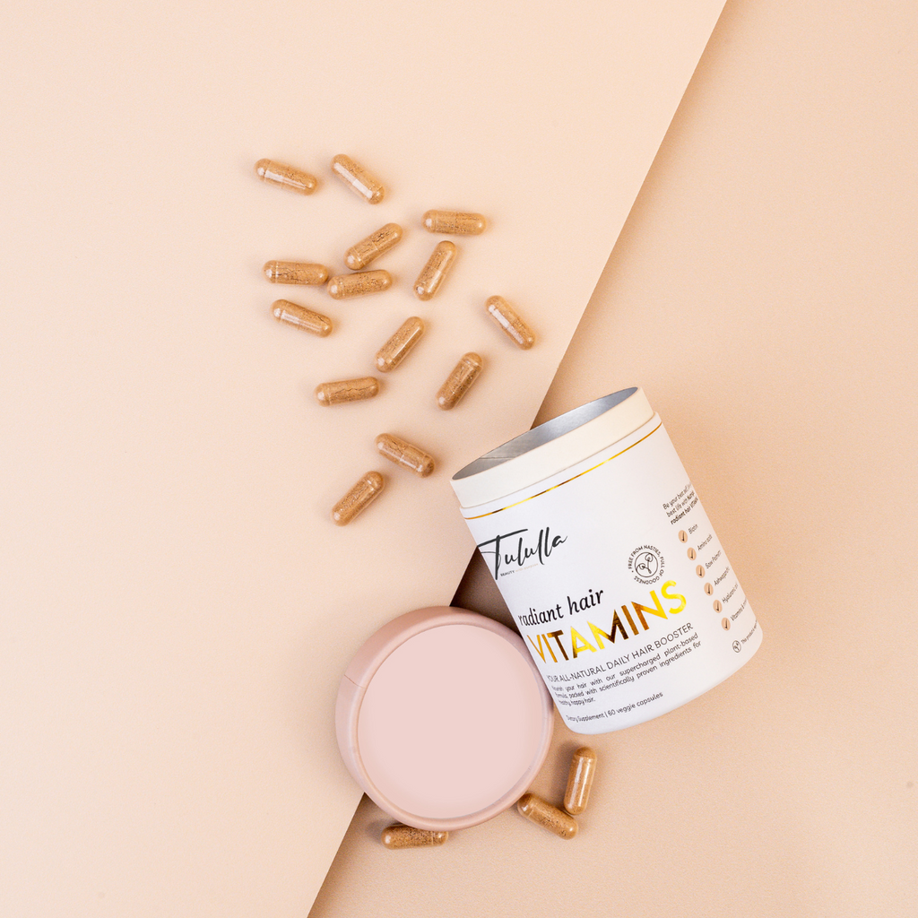 Radiant Hair Vitamin capsules falling out of eco-friendly packaging